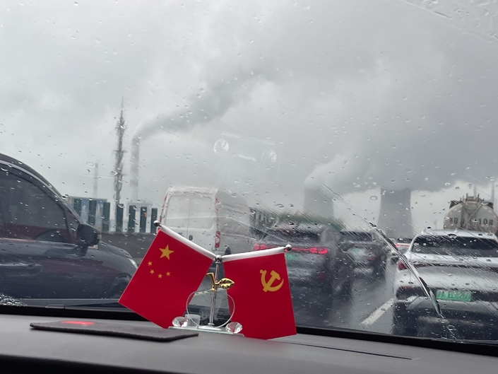Une sortie de Shanghai sous le signe du drapeau chinois, de la pluie et des bouchons. Photo : Caradisiac.
