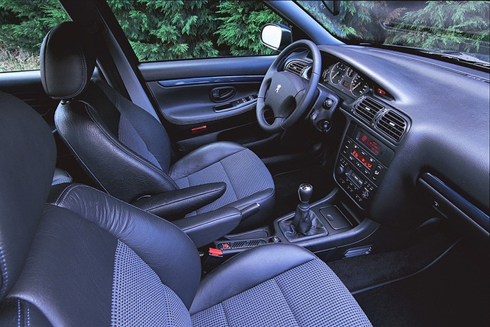 Belle sellerie mixte cuir/tissu de série dans la Peugeot 406 2.2 Sport initiale, en 2000. L'équipement se révèle, par ailleurs, très complet sans qu'on ait à recourir aux options.